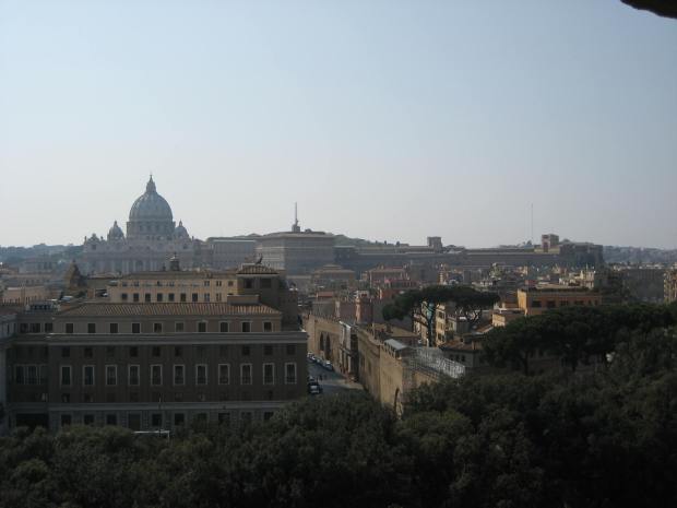 From the top of Castel Sant'Angelo, the dome of St. Peter's Basilica stands against the skyline.